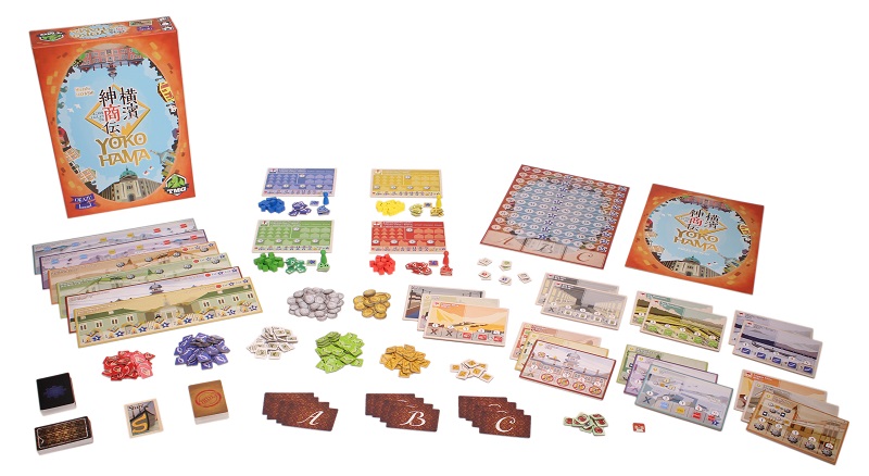 Yokohama game components laid out, including board game box, tokens, cards, player game boards, rulebook, miniatures and game board