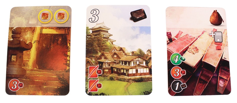 three game cards laid out next to each other, depicting art from the game